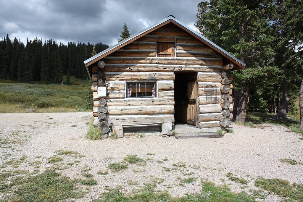 A log cabin in a mountain meadow in the Rio Grande National Forest