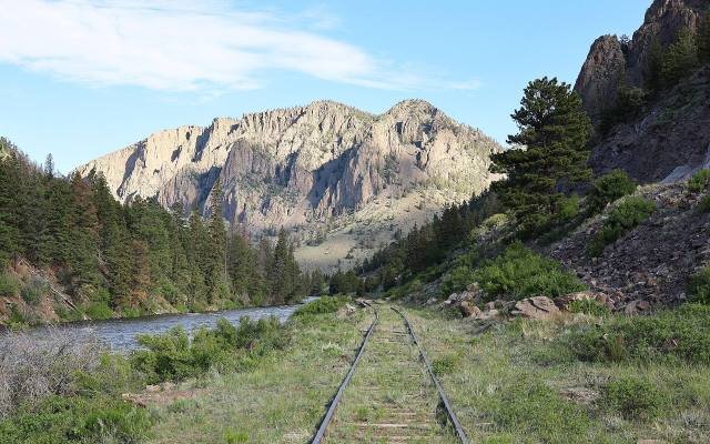 The old railroad grade of the Creede Branch running beside the Rio Grande below cliffs